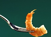 Cooked shrimp tail on a fork