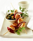 Fried rabbit kebabs on spinach and lentils