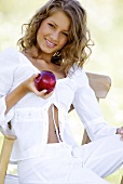 Young woman holding a red apple