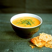 Creamed carrot soup with chives in small bowl