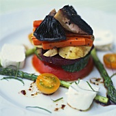 Vegetable tower with goat's cheese and strips of basil
