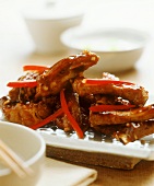 Pork ribs in sweet chili sauce with strips of pepper