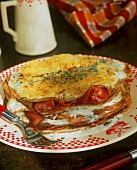 Pile of pancakes with cheese & ham & toasted cheese topping