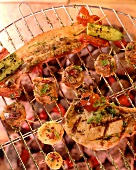 Various barbecue foods on grill rack