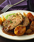 Roast lamb in onion sauce with potatoes and pea puree