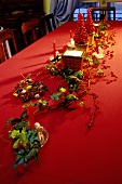 Christmas table decoration with ivy and rose hips