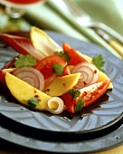 Tomato and onion salad with pieces of mango