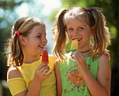Two girls licking ice creams