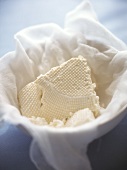 Ricotta in a bowl with cloth