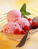 Raspberry yoghurt ice cream in glass bowl