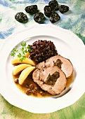 Roast pork roll with dried fruit stuffing & red cabbage