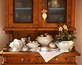 White crockery with Christmas decoration on kitchen cabinet