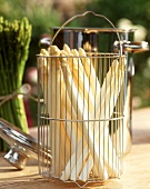 Peeled asparagus spears in perforated insert for asparagus pan