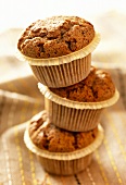 Three chocolate muffins on top of each other