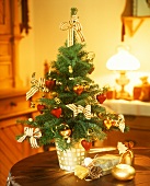 Small Christmas tree and sack of presents on a table