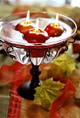 Apple-shaped floating candles as table decoration