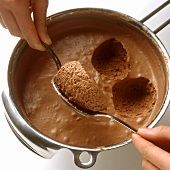 Spooning out spoonfuls of mousse au chocolat