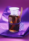 Plums in red wine with cinnamon in jar as Christmas gift
