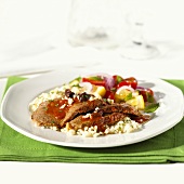 Roast beef with tomato sauce, feta, olives and rice