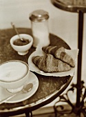 Bistro table with café au lait, croissants and jam