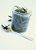 Samphire in preserving jar, spoonful of peppercorns in front