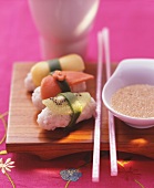 Sushi with fruit and sesame and honey dip