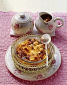 Hot bread pudding with flaked almonds and apple puree