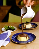Vanillepudding mit Schokoladensauce übergiessen