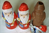 Chocolate Santas, one with a bite taken (grainy effect)