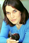 Young woman with glass of red wine (grainy effect)