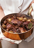 Coq au vin in a copper pan