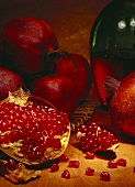 Opened pomegranate in front of whole pomegranates
