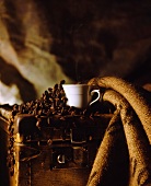 Coffee cup and coffee beans in rustic setting
