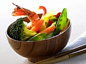 Bowl of vegetables and shrimps; chopsticks