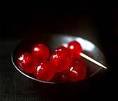 Cocktail cherries in a black bowl