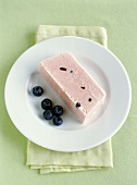 A piece of watermelon parfait with blueberries on plate