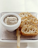 Truffle cream in small bowl with slices of white bread