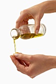 Woman pouring oil onto her hand