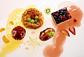 Tarts, pastry and piece of cake with fruit and cake glaze