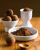 Several chocolate truffles with cocoa