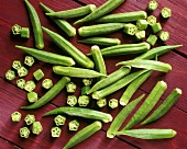 Several okra pods, cut open and whole