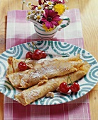 Filled pancakes (Palatschinken) with nuts and cherries