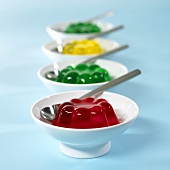 Four dishes of jelly in a row