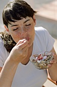 Young woman eating muesli