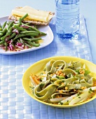 Lentils with green noodles with lukewarm bean salad
