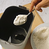 Putting flour into bread machine