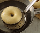 Making bagels: placing in boiling water