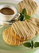 Small apple cakes with stripes of glacé icing