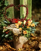Winter arrangement of fir with roses and Erica heart
