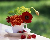 Table decoration: mixed flowers in a coffee cup